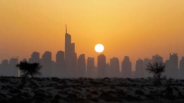 The sun sets behind the city skyline at the Marina district as the Almas tower is seen in Dubai, United Arab Emirates. (AP)