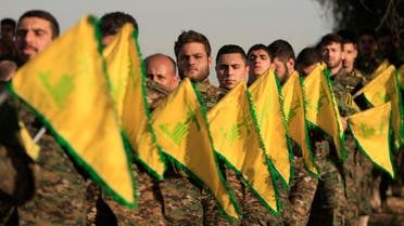 Hezbollah fighters hold flags as they attend the memorial of their slain leader Sheik Abbas al-Mousawi, who was killed by an Israeli airstrike in 1992, in Tefahta village, south Lebanon, Saturday, Feb. 13, 2016. (AP)