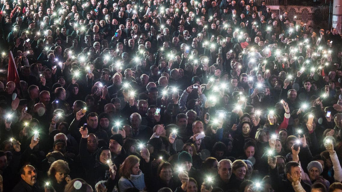 People hold up their smartphones as they take part in a demonstration in Artvin, northeastern Turkey, to protest against the controversial plans to build a gold and copper mine in the ecologically pristine area, on February 23, 2016. AfP