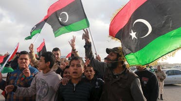 Libyans wave their national flags as they celebrate Libya's eastern government's gains in the area, in Benghazi, Libya, February 24, 2016. (Reuters)