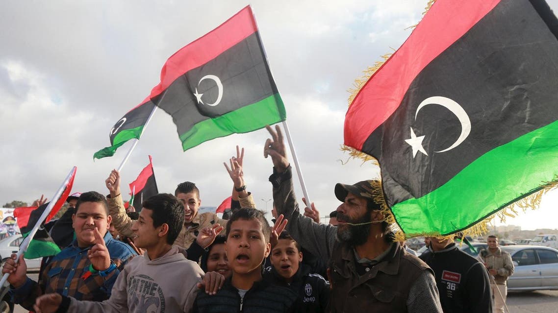 Libyans wave their national flags as they celebrate Libya's eastern government's gains in the area, in Benghazi, Libya, February 24, 2016. REUTERS