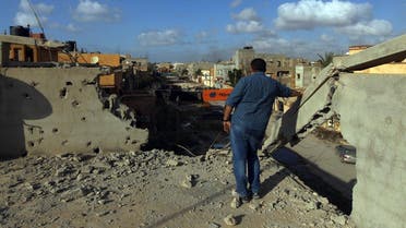 A man stands on a roof of a building after fighters loyal to Libya's internationally recognized government seized the centre of the eastern coastal city of Benghazi. (AFP)