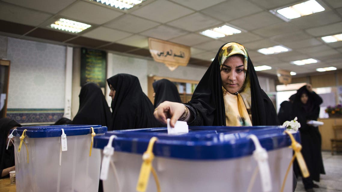 An Iranian woman casts her ballot to vote for both parliamentary elections and Assembly of Experts at a polling station at Massoumeh shrine in the holy city of Qom, 130 kms south of Tehran, on February 26, 2016. AFP