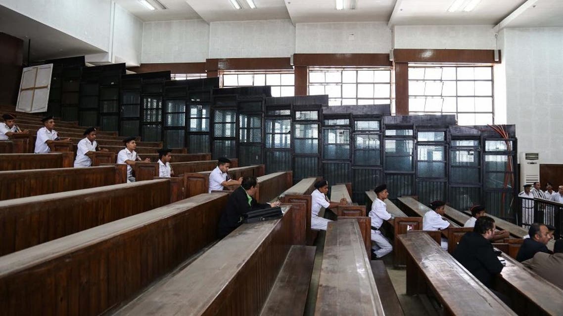 Policemen guard a courtroom holding Gamal and Alaa Mubarak, sons of deposed president Hosni Mubarak, in Tora Prison, Cairo, Egypt, Monday, Oct. 12, 2015. The Egyptian court ordered the release of Gamal, Mubarak's one-time heir apparent, and his brother Alaa, a wealthy businessman, after time served on a corruption conviction. Many Egyptians view the brothers as key symbols of an autocratic and corrupt administration that struck an alliance with the mega-wealthy at the expense of the poor. (AP Photo/Mohamed Elraai)