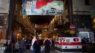 In this Wednesday, Feb. 24, 2016 file photo, a poster of Syrian President Bashar Assad hangs at the popular Souk Tawil old market in Damascus, Syria.  (AP)