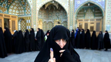 An Iranian woman displays her ink-stained finger after voting in the parliamentary and Experts Assembly elections at a polling station in Qom, 125 kilometers south of the capital Tehran, Iran, Friday, Feb. 26, 2016. (AP)