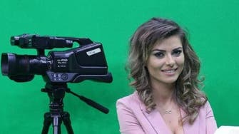 Albanian TV newsreaders get almost-topless to boost audience 