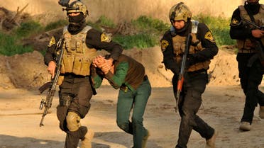 Members of the Iraqi Special Operations Forces arrest a suspected militant during a raid operation in Abu Ghraib district, west of Baghdad, February 24, 2014. Picture taken February 24, 2014. (Reuters)