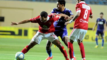 Al Ahly's Ahmed Fathy, left, tries to keep the ball against Zamalek's Mahmoud Kahraba, center, during their Egyptian Cup soccer match at the Petrosport Stadium in Cairo, Egypt, Monday, Sept. 21, 2015. (AP)