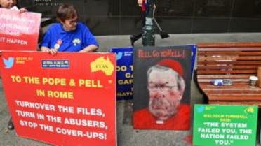 Protesters hold placards outside the Royal Commission into Institutional Responses to Child Sexual Abuse in Sydney on February 29, 2016, as Australia’s Cardinal George Pell gave evidence via video-link from a hotel in Rome to the Royal Commission rather than appearing in person as he has a heart condition. (AFP)