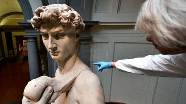 An Italian restorer from the Friends of Florence Association cleans Michelangelo's David, one of the world's most famous statues, at the Galleria dell'Accademia in Florence. (AFP)