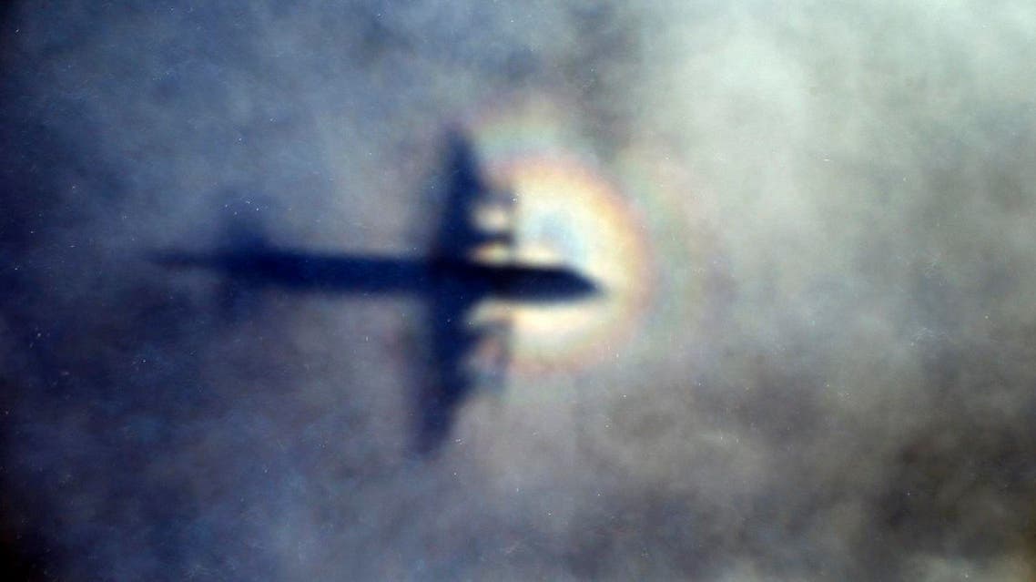 In this March 31, 2014 file photo, the shadow of a Royal New Zealand Air Force P3 Orion is seen on low level cloud while the aircraft searches for missing Malaysia Airlines Flight MH370 in the southern Indian Ocean, near the coast of Western Australia. Australian authorities said Thursday, Dec. 3, 2015 new analysis confirms they've likely been searching in the right place for a missing Malaysian airliner. (AP Photo/Rob Griffith, File)