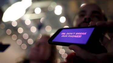 A man displays a protest message on his iPhone at a small rally in support of Apple's refusal to help the FBI access the cell phone of San Bernardino gunman in California. (Reuters)