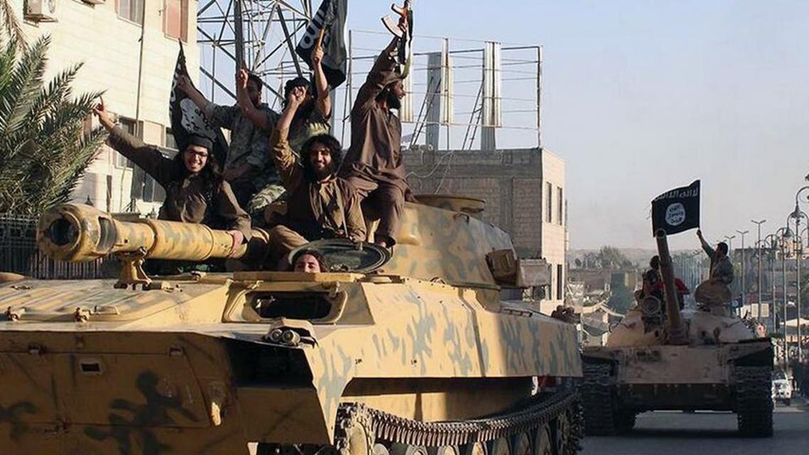 In this undated file image posted by the Raqqa Media Center, in Islamic State group-held territory, on Monday, June 30, 2014, which has been verified and is consistent with other AP reporting, fighters from the Islamic State group ride tanks during a parade in Raqqa, Syria. (Raqqa Media Center via AP, File)