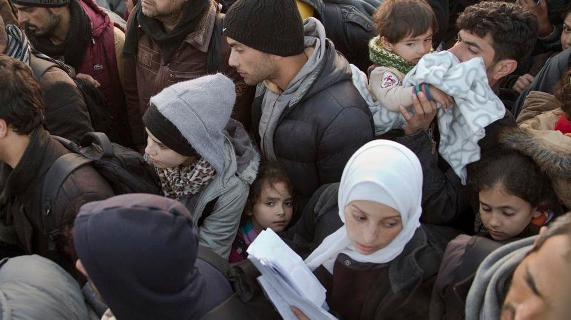 Refugees crowd before crossing the border from the Greek side to Macedonia at the northern Greek border station of Idomeni Wednesday, March 2, 2016. Greek police said up to 10,000 mostly Syrian and Iraqi refugees were stuck at the Idomeni border crossing in deteriorating conditions. (AP Photo/Petros Giannakouris)