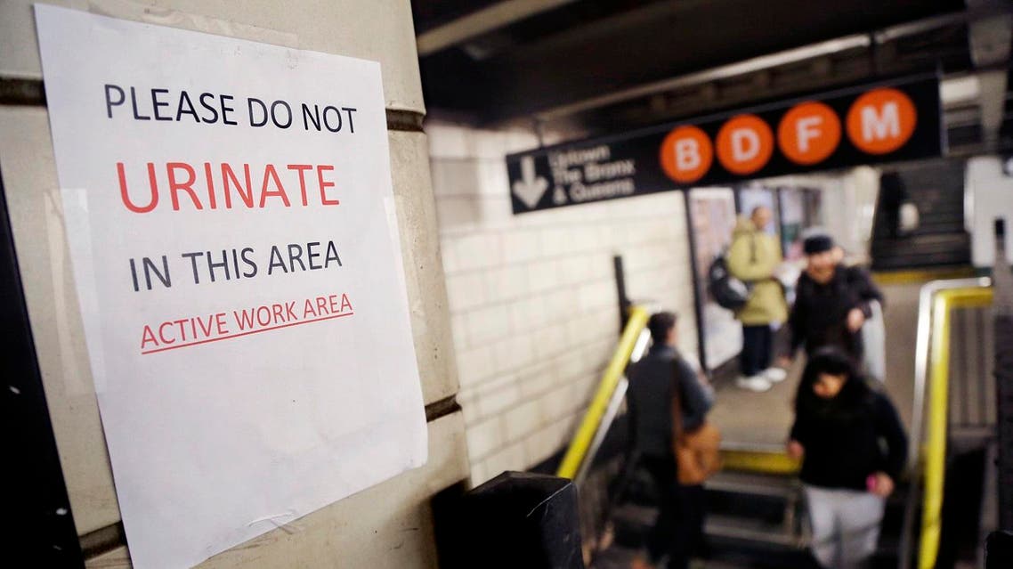 A sign hangs in the West 4th Street subway station reads "Please Do Not Urinate In This Area - Active Work Area." (AP)