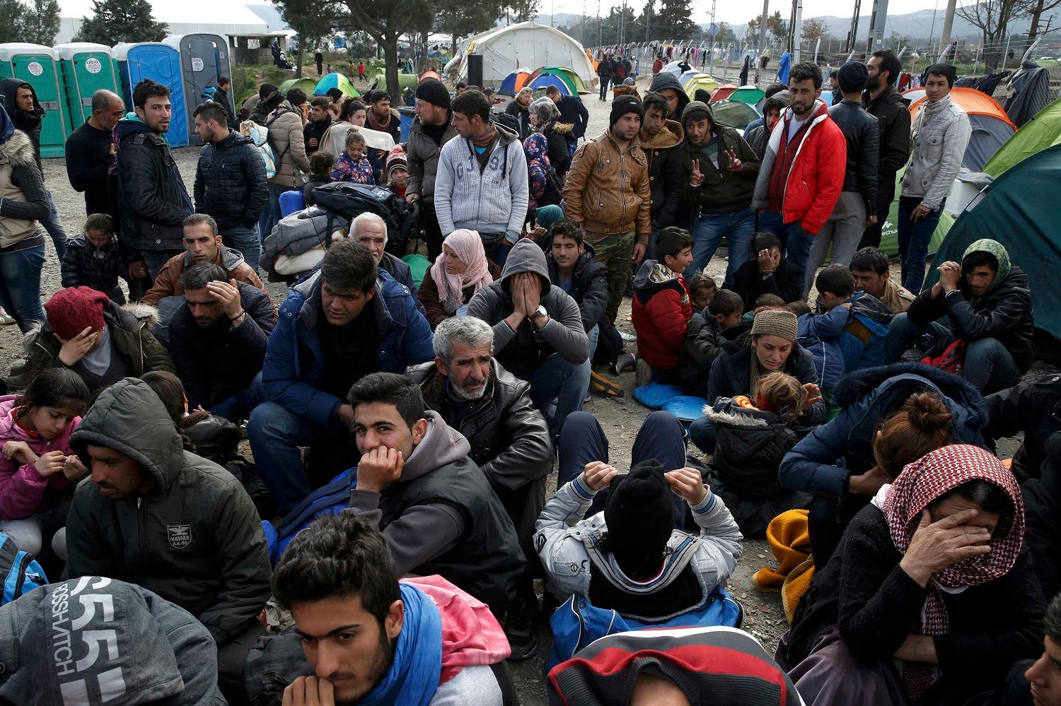 Migrants queue to receive travel papers near the Greek-Macedonian border, near the village of Idomeni, Greece March 2, 2016. REUTERS