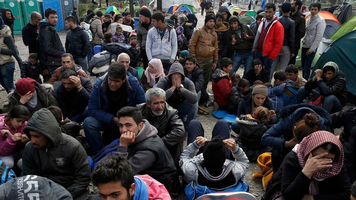 Migrants queue to receive travel papers near the Greek-Macedonian border, near the village of Idomeni, Greece March 2, 2016. REUTERS