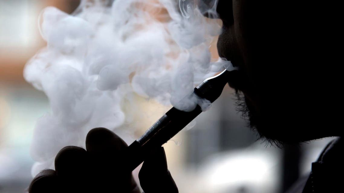 In this April 23, 2014 file photo, a man smokes an electronic cigarette in Chicago. On Tuesday, Jan. 5, 2016, the U.S.'s lead public health agency focused its attack on electronic cigarettes on the issue of advertising, saying too many kids see the ads. There are bans on TV commercials and some other types of marketing for regular cigarettes but there are no restrictions on advertisements for e-cigarettes. Most states, though, ban the sale of e-cigarettes to minors. (AP Photo/Nam Y. Huh, File)