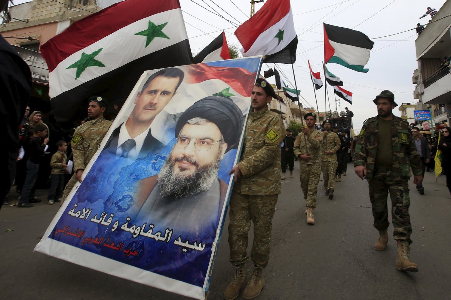 Members of the Arab Socialist Baath Party carry a picture depicting Syria's President Bashar al-Assad and Hezbollah leader Hassan Nasrallah. (Reuters)