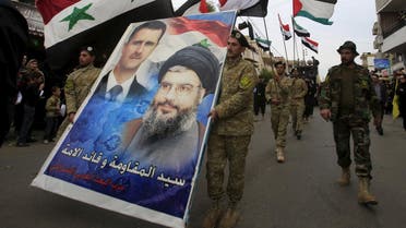 Members of the Arab Socialist Baath Party carry a picture depicting Syria's President Bashar al-Assad and Hezbollah leader Hassan Nasrallah. (Reuters)