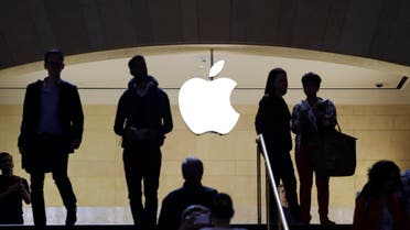 In this May 22, 2015 photo, customers and staff stand in the entrance to an Apple store in New York's Grand Central Terminal. AP