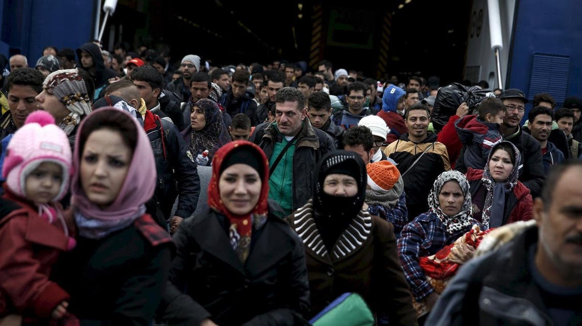 Refugees and migrants arrive aboard the passenger ferry Blue Star Patmos from the island of Lesbos at the port of Piraeus, near Athens, Greece, in this October 29, 2015 file photo. European Union leaders meet on March 7, 2016 to debate how to end the migrant crisis before a second summer of chaos, but they have already long known the available answers -- and why they have yet to add up to a solution. REUTERS
