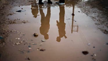 In this Wednesday, Dec. 12, 2012 photo, Free Syrian Army fighters are seen reflected in running water in the northern province of Aleppo, Syria.  (AP)