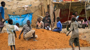 Children play outside their shelter during a visit by the UN Security Council delegation at the Mandela camp for displaced southern Sudanese, south of the capital Khartoum, in Sudan Sunday, May 22, 2011. AP