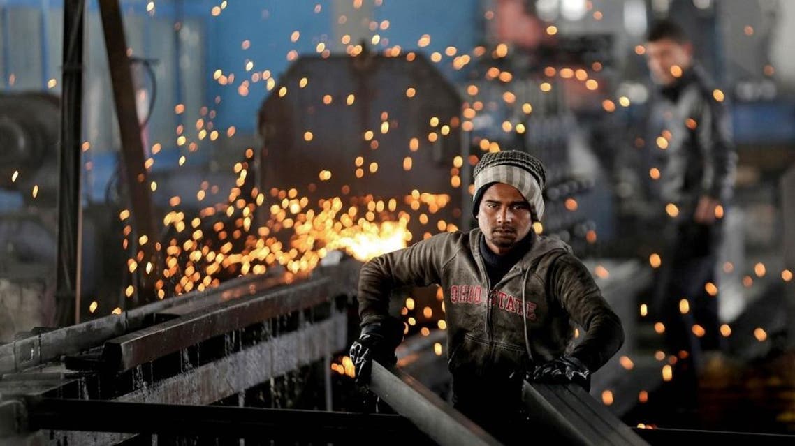 In this Thursday, Feb. 25, 2016 photo, a worker from India arranges steel tubes at a factory in the Muwaqer Industrial Estate, in northern Jordan (AP)
