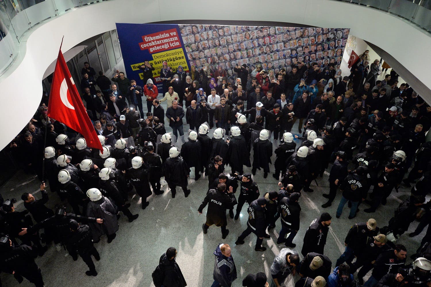 Riot police enter the headquarters of Zaman newspaper in Istanbul, late Friday, March 4, 2016 after a local court ordered that Turkey's largest-circulation, opposition newspaper, which is linked to a U.S.-based Muslim cleric, be placed under the management of trustees _ a move that heightens concerns over deteriorating press freedoms in Turkey. AP