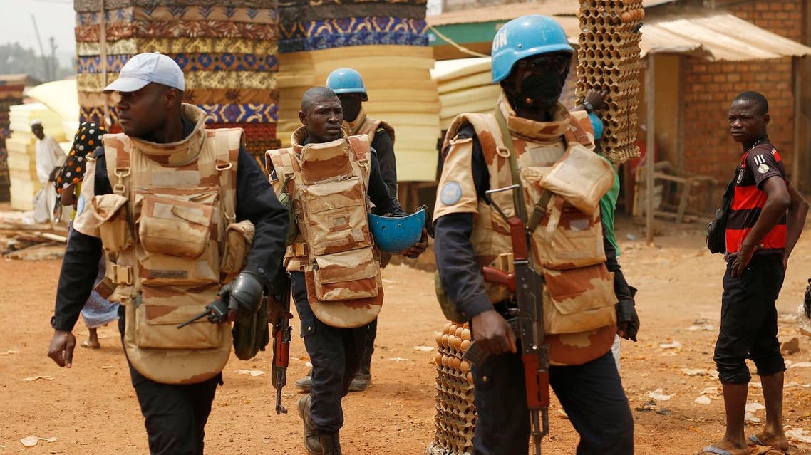 UN peacekeepers from Congo Brazaville walk in the PK5 district after unloading a truck of its voting material and ballots at a polling station in Bangui, Central African Republic, Saturday Feb. 13, 2016. AP