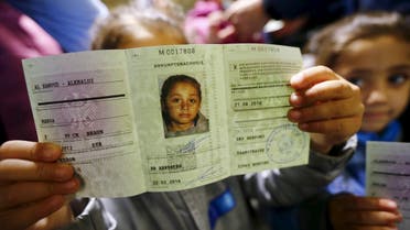 Four-year-old Syrian girl Maroa from the eastern Syrian town of Deir ez-Zor presents her newly issued "Ankunftsnachweis", an initial German registration document for migrants, following her family's registration at the former British Harewood barracks in Herford, western Germany February 22, 2016. (Reuters)