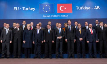 Turkish Prime Minister Ahmet Davutoglu (C) poses with European Union leaders during a EU-Turkey summit in Brussels, as the bloc is looking to Ankara to help it curb the influx of refugees and migrants flowing into Europe, March 7, 2016. REUTERS/Yves Herman