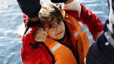Greek Coast Guard officers move a girl from a dinghy carrying refugees and migrants aboard the Ayios Efstratios Coast Guard vessel, during a rescue operation at open sea between the Turkish coast and the Greek island of Lesbos, February 8, 2016. (Reuters)