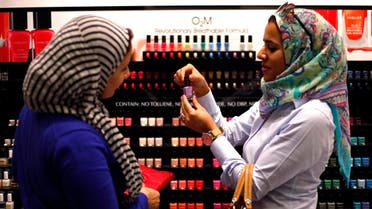 Two Egyptian women buy "breathable" nail polish from a store in a Dubai shopping mall November 18, 2013. (Reuters)