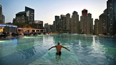 In this April 12, 2015 photo, a man dives into a hotel pool in the Marina neighborhood of Dubai, United Arab Emirates. (AP)