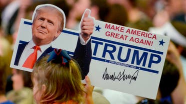 A young supporter holds up a campaign sign for U.S. Republican Presidential candidate Donald Trump at a campaign rally in Madison Mississippi. (Reuters)