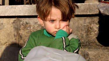 A girl waits to fill water containers in Bab Neirab, Aleppo, Syria February 15, 2016. (Reuters)