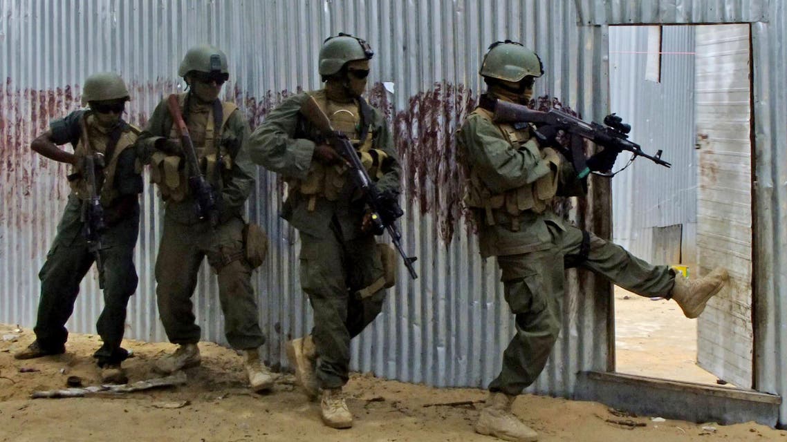 Masked Somali national army (SNA) soldiers search through homes for al-Shabaab fighters, during an operation in Ealsha Biyaha, Somalia, Saturday, June, 2, 2012