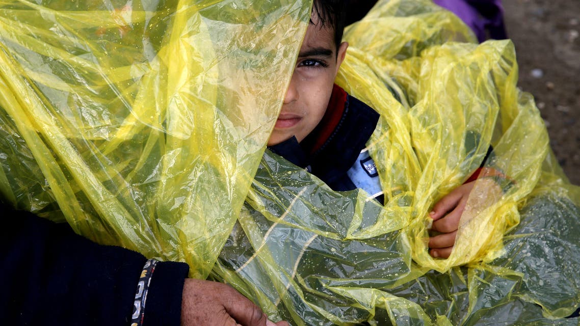 A young migrant takes a rest as he walks with other migrants towards a makeshift camp at the Greek-Macedonian border, near the Greek village of Idomeni, Greece March 4, 2016. (Reuters)