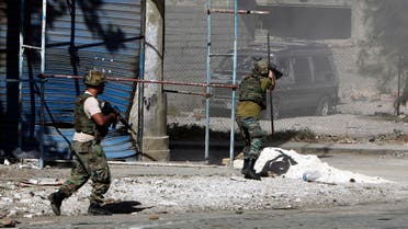 Lebanese army soldiers open fire during clashes with Islamic militants in the northern port city of Tripoli, Lebanon, Sunday, Oct. 26, 2014. AP