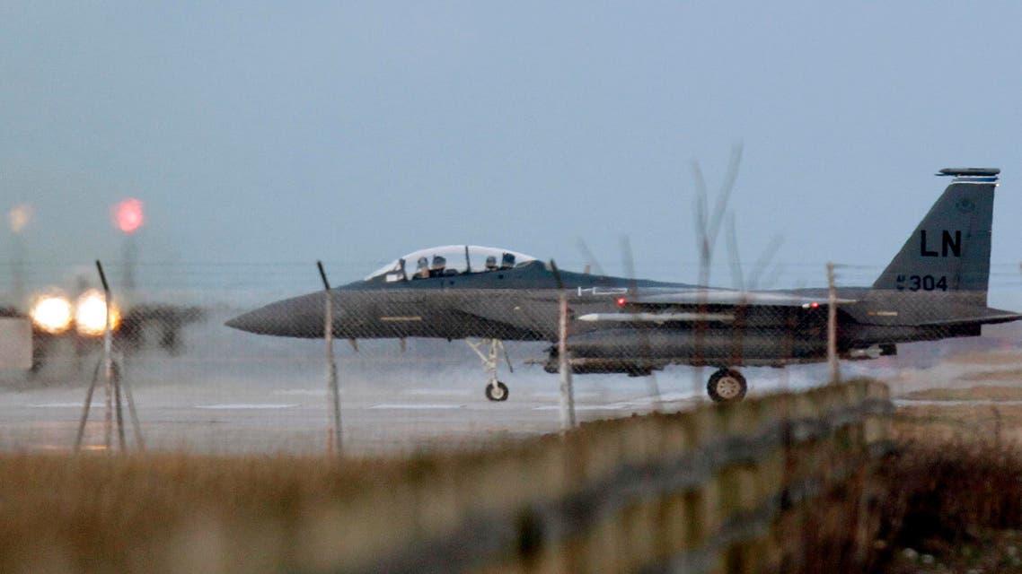 A USAF F-15 jet fighter maneuvers as another F-15 takes off from the NATO airbase in Aviano, Italy, Monday, March 21, 2011. (AP)