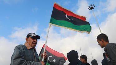 A Libyan man waves the national flags as he celebrates Libya's eastern government's gains in the area, in Benghazi, Libya reuters