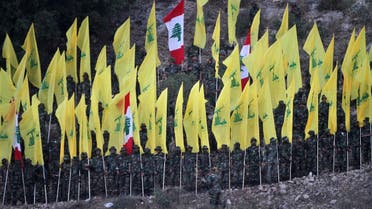  In this August 14, 2015, file photo, Hezbollah fighters hold their group and Lebanese flags, as they perform during a rally marking the ninth anniversary of the 2006 Israel-Hezbollah war, at the southern Lebanese village of Wadi al-Hujair, Lebanon. A Saudi-led bloc of six Gulf Arab nations formally branded Hezbollah a terrorist organization on Wednesday, ramping up the pressure on the Lebanese militant group fighting on the side of President Bashar Assad in Syria. (AP Photo/Mohammed Zaatari, File)