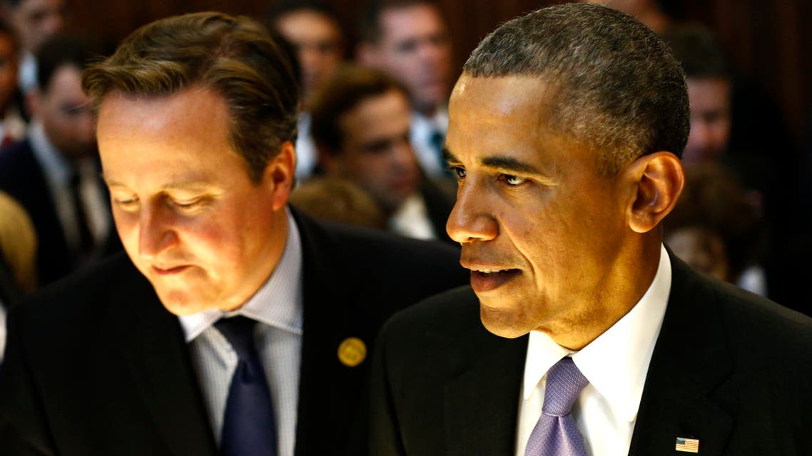 U.S. President Barack Obama, right, walks with British Prime Minister David Cameron, left, at the G-20 summit in Antalya, Turkey, Monday, Nov. 16, 2015. The leaders of the Group of 20 wrapped up their two-day summit near the Turkish Mediterranean coastal city of Antalya Monday against the backdrop of heavy French bombardment of the Islamic State's stronghold in Syria. The bombings marked a significant escalation of France's role in the fight against the extremist group. (Anadolu Agency via AP, Pool)