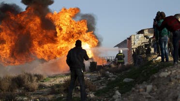 Civil Defense members put out a fire that spread in an oil refinery in the town of Marat Numan in Idlib province, Syria March 10, 2016. REUTERS