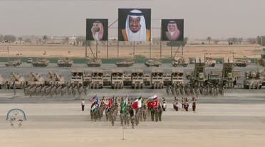 Flags of participating armies march during the ceremony. (Al Arabiya)