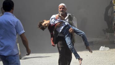 ATTENTION EDITORS - VISUAL COVERAGE OF SCENES OF INJURY OR DEATH A man carries a boy wounded in what the Free Syrian Army said was an air raid by forces loyal to Syrian President Bashar al-Assad in the Duma district area near Damascus, Syria July 13, 2013. REUTERS/Bassam Khabieh TEMPLATE OUT SEARCH 'FIVE YEARS SYRIA' FOR ALL IMAGES