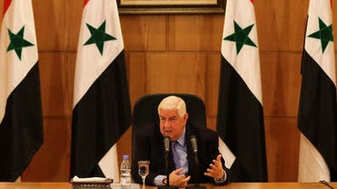 Syrian Foreign Minister Walid al-Muallem speaks in front of a portrait of Syrian President Bashar al-Assad during a press conference on March 12, 2016 in the capital Damascus. Syrian President Bashar al-Assad's ouster remains a "red line" for the government, Muallem said ahead of fragile peace talks in Geneva.
